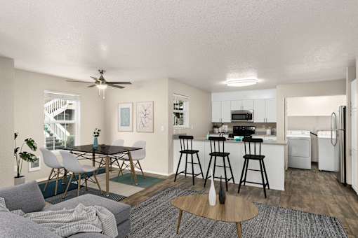 A modern kitchen with a dining table and chairs.