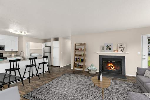 A living room with a fireplace and a dining area in the background.