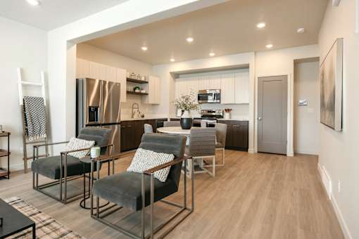 A modern kitchen with a dining area and a refrigerator.
