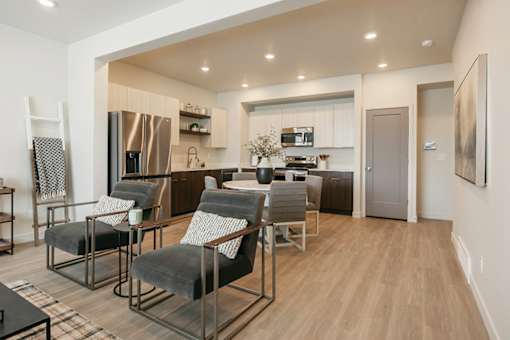 A modern kitchen with a dining area and a refrigerator.