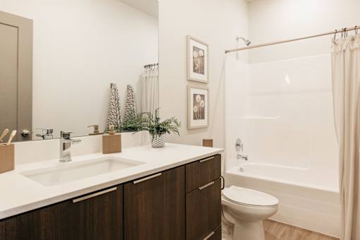 A bathroom with a white sink and a white toilet.