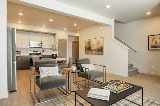 A modern living room with a grey sofa and a coffee table.