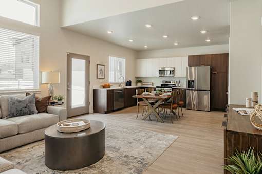 A modern kitchen with a dining table and chairs.