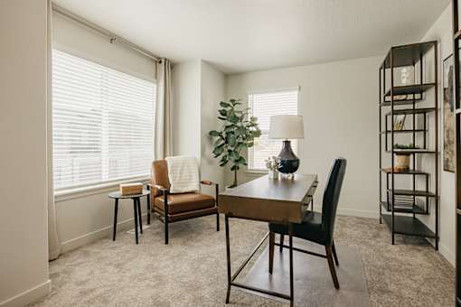 A living room with a brown chair and a wooden table.