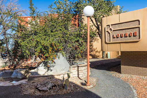 A sign that says "LOUNGE" is mounted on a wall.
