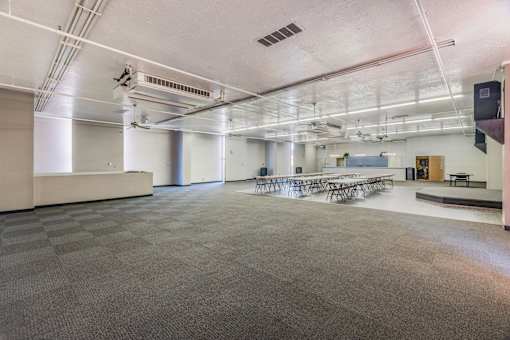 A large, empty room with a checkered floor and white walls.