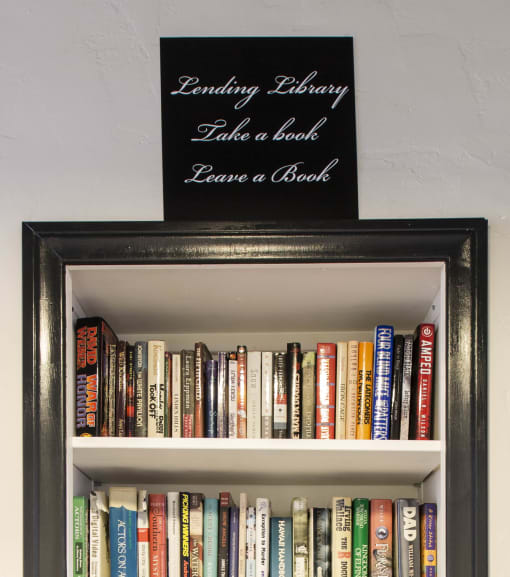 a book shelf with a sign saying loving library take a book bring a book at Del Mor, Los Angeles, 90026