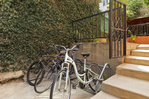 a group of bikes parked next to some stairs