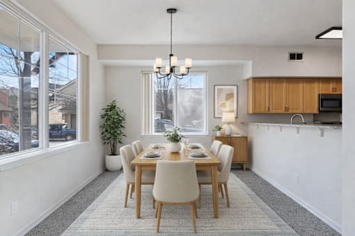 A dining room with a table set for six.