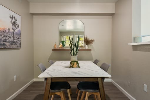 a dining room with a table and chairs at Odyssey Ridge, Albuquerque, 87114