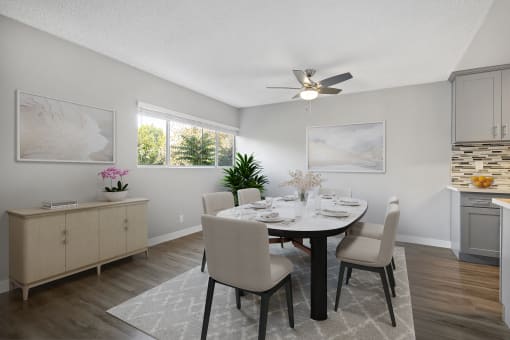a dining room with a table and chairs and a ceiling fan at The Fulton, Los Angeles, CA