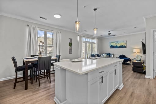 an open concept kitchen and living room with an island and a dining table