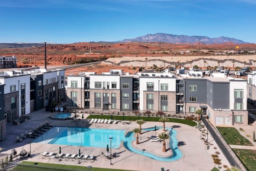 an aerial view of an apartment complex with a large swimming pool
