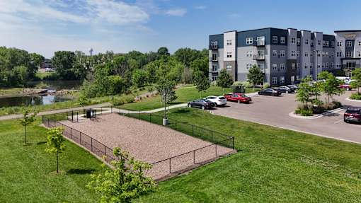 A park area with a fence and a playground.