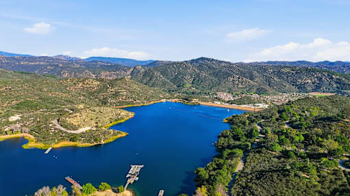 A large body of water surrounded by greenery and mountains in Escondido, CA.