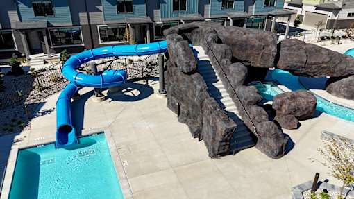 A blue water slide in a pool.