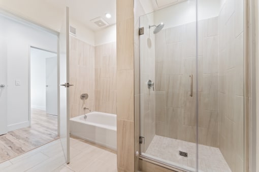a large white bathroom with a shower and a tub