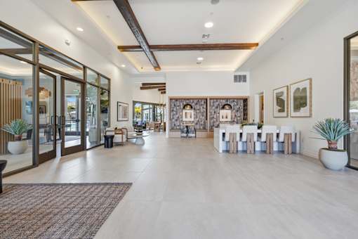 A spacious room with a long table set for a meeting.