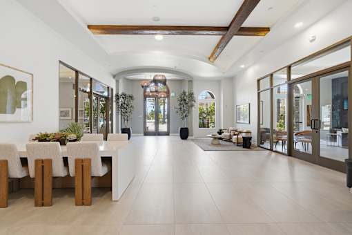 A spacious dining area with a long table and chairs.