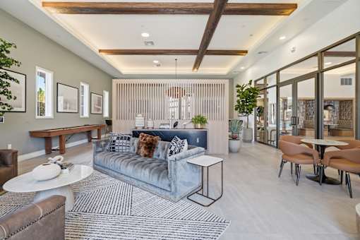 A modern living room with a grey sofa and a wooden coffee table.