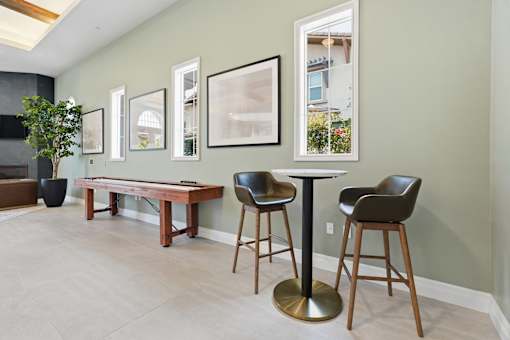 A room with a table and chairs and pictures on the wall.