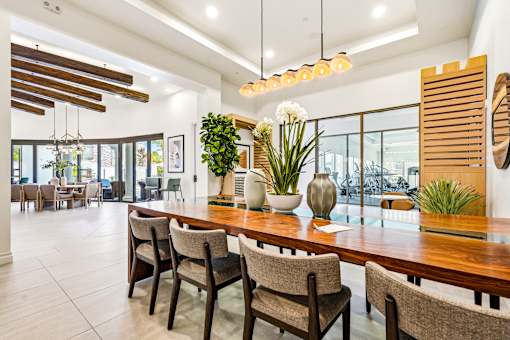 A dining room with a long table and chairs.