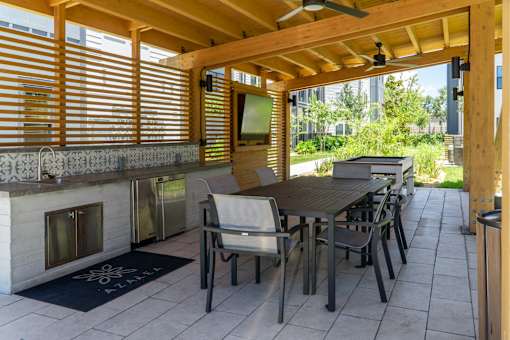 A patio with a table and chairs and a fireplace.