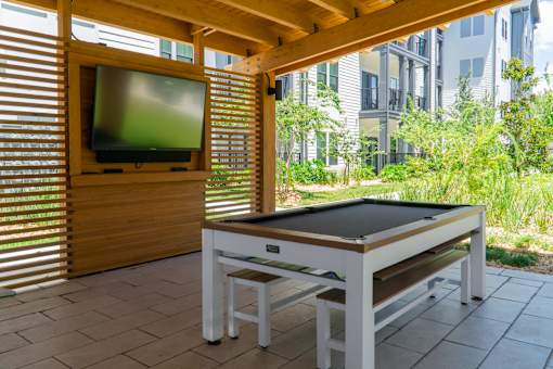 A table tennis table is set up on a patio.