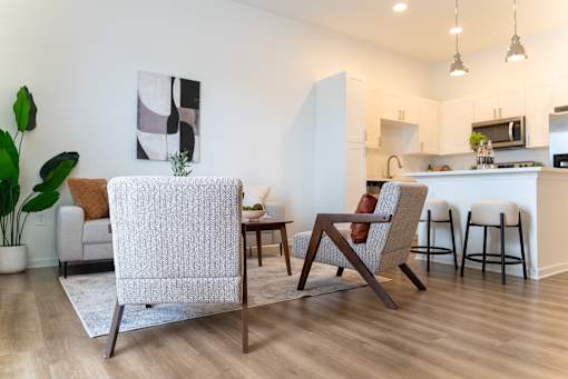A modern living room with a white chair and a brown couch.
