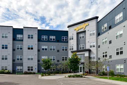 A large, modern building with the word "Apex" on the top.