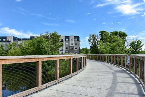 A bridge with a railing and a walkway in the middle of it.