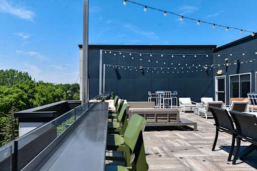A patio with a table and chairs is set up on a balcony.