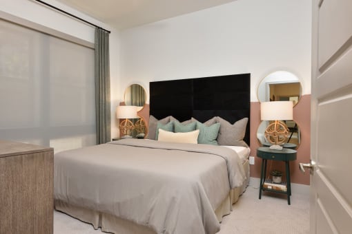 Bedroom with cozy bed at The Flats at West Alabama, Houston, TX