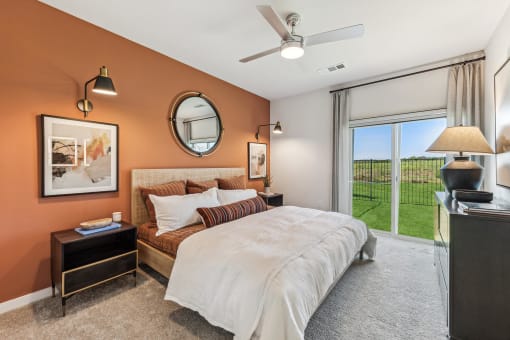 a bedroom with a bed and a ceiling fan
