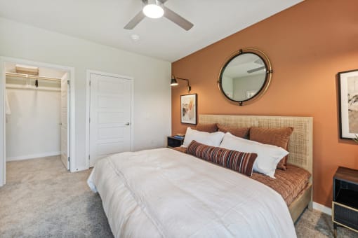 a bedroom with a bed and a ceiling fan