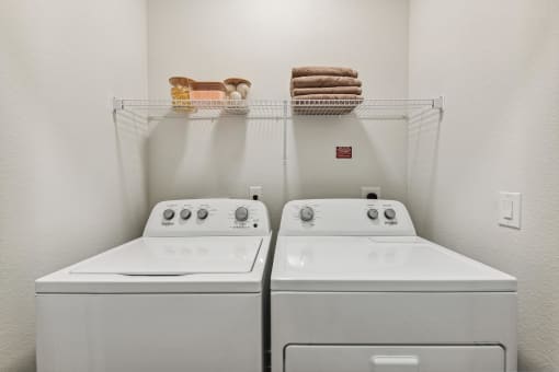 two washers and a dryer in a laundry room