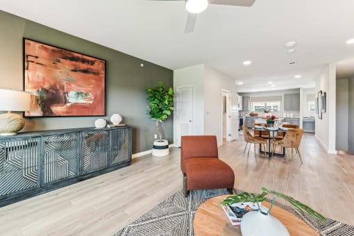 a living room and dining room with a table and chairs