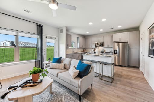 a living room and kitchen with a couch and a table