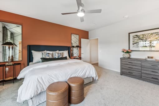 a bedroom with a bed and a ceiling fan