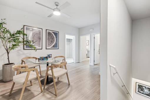 a dining room with a glass table and chairs