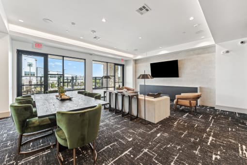 a conference room with a table and chairs and a television