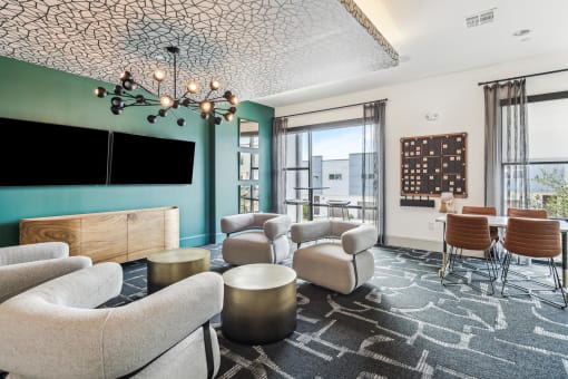 a living room with couches and chairs and a tv