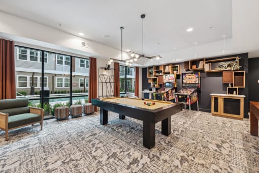 a game room with a pool table and a bar