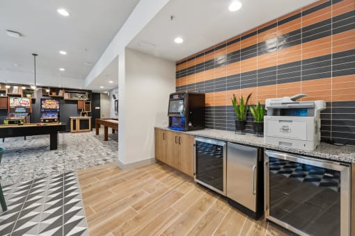 a clubhouse with a coffee machine and a counter with a vending machine