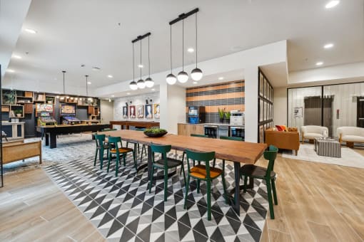 a dining area with a table and chairs and a living room with a pool table