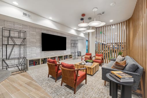 a living room with chairs and a tv