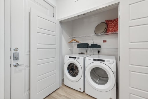 a washer and dryer in a laundry room with a white door