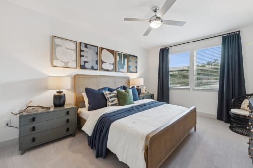 a bedroom with a bed and a ceiling fan