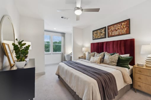 a bedroom with a bed and a ceiling fan