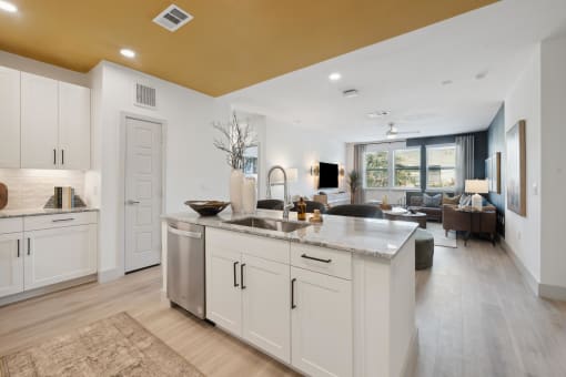 a kitchen with white cabinets and a large counter top